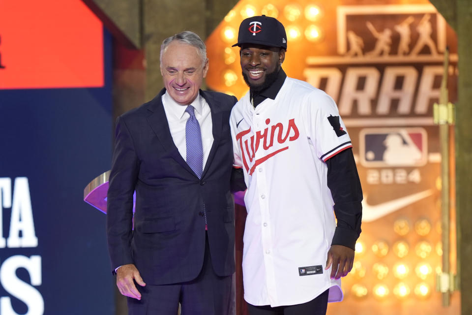 Major League Baseball Commissioner Rob Manfred, left, and Kaelen Culpepper, right, pose for a photo after Culpepper was selected 21st overall by the Minnesota Twins in the first round of the MLB baseball draft in Fort Worth, Texas, Sunday, July 14, 2024. (AP Photo/LM Otero)