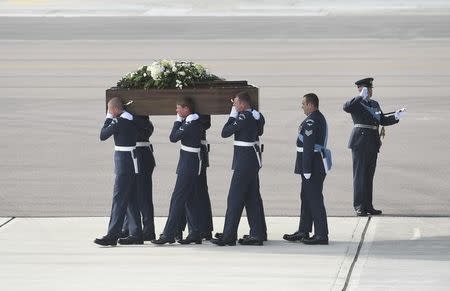 The coffin of Adrian Evans, one of the British nationals killed in the Tunisia terror attack, is carried from an RAF C17 after his repatriation at RAF Brize Norton near Oxford in Britain July 1, 2015. REUTERS/Joe Giddens/Pool