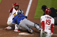 St. Louis Cardinals' Ali Sanchez, left, is tagged out at home by New York Mets catcher Tomas Nido as Cardinals' Tommy Edman (19) watches ending the second inning in the second game of a baseball doubleheader Wednesday, May 5, 2021, in St. Louis. (AP Photo/Jeff Roberson)