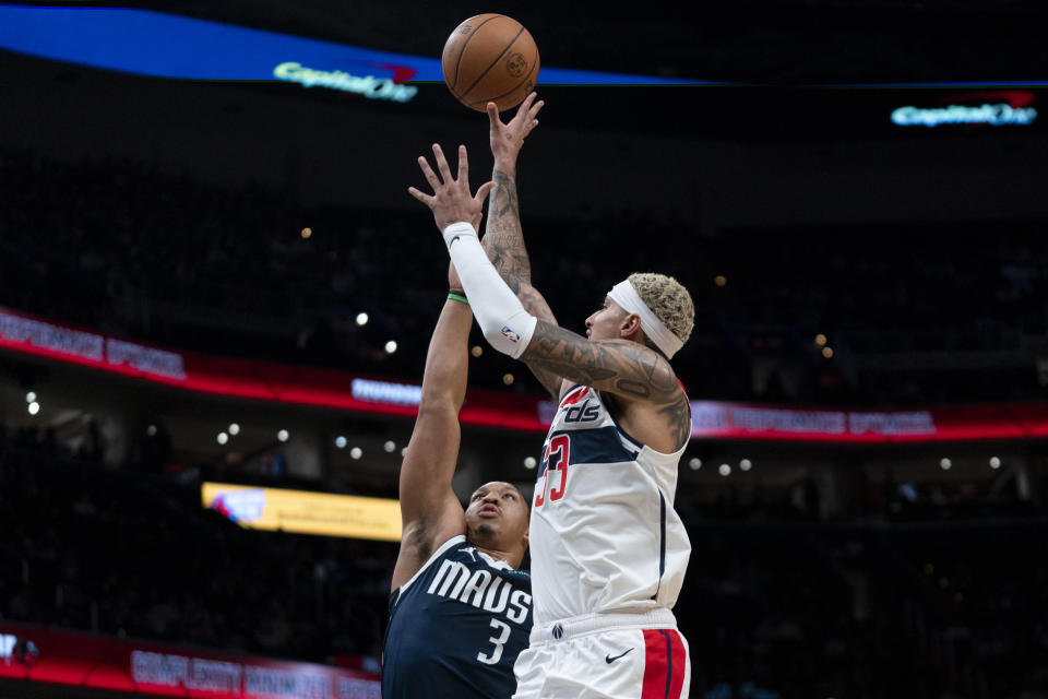 Washington Wizards forward Kyle Kuzma (33) shoots against Dallas Mavericks forward Grant Williams (3) during the first half of an NBA basketball game Wednesday, Nov. 15, 2023, in Washington. (AP Photo/Stephanie Scarbrough)