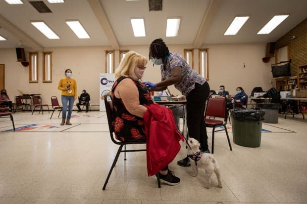 Nurses with Humber River Hospital administer first doses of the Moderna COVID-19 vaccine to residents of an apartment building in Toronto’s Jane and Wilson neighbourhood on Apr. 13, 2021. (Evan Mitsui/CBC - image credit)