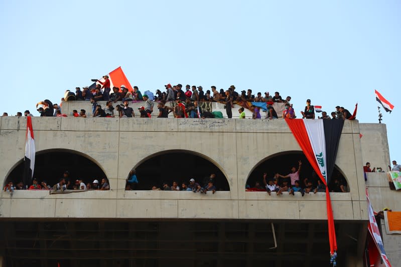 Iraqi demonstrators are seen inside the high-rise building, which is called by Iraqi the Turkish Restaurant Building, during anti-government protests in Baghdad