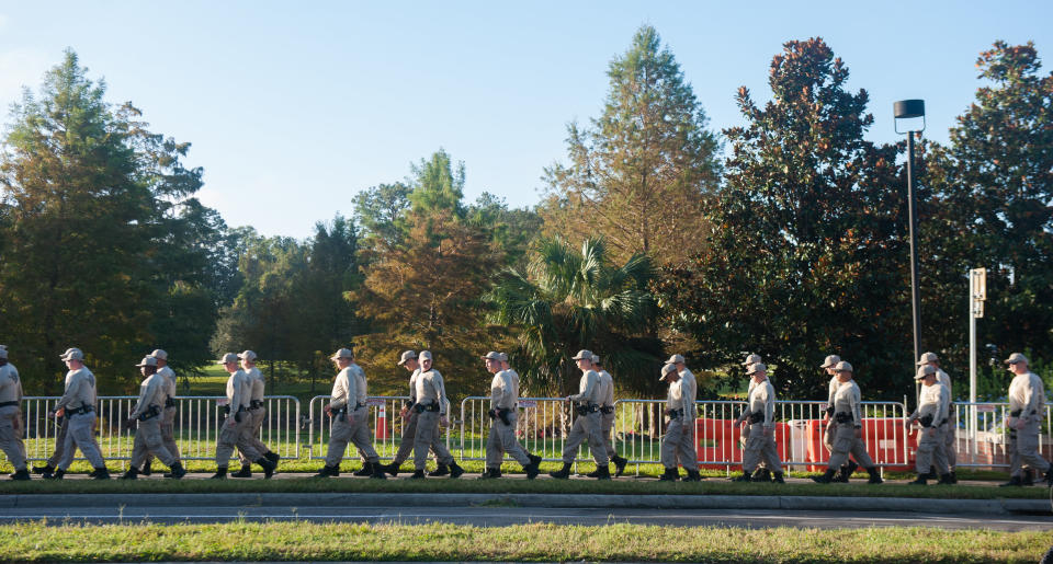 Florida State Troopers walk from their hotel to the University of Florida Campus before a speaking event by Richard Spencer on Thursday, October 19, 2017 in Gainesville.