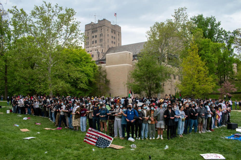 More than 100 pro-Palestinian protesters link arms to surround an encampment outside the Indiana Memorial Union in Bloomington on April 26. Inside the encampment, there was food, medical supplies, tents, and a pile of backpacks. <span class="copyright">Mia Hilkowitz for The Indiana Daily Student</span>