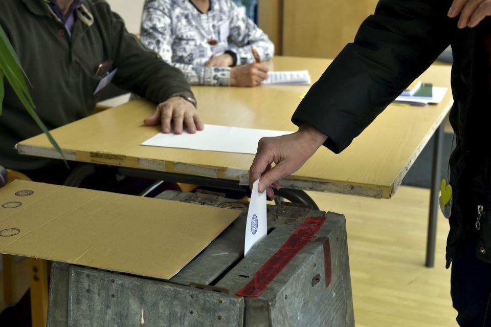 Citizens cast their votes during Finnish parliamentary elections, at the town hall in Manstala, Finland on Sunday, 14th April, 2019. Finns went to the polls in parliamentary elections on Sunday. (Emmi Korhonen/Lehtikuva via AP)