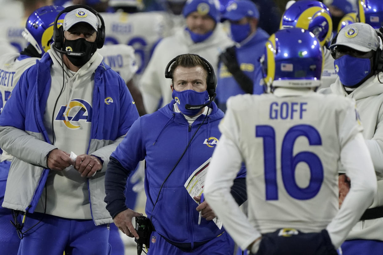 Los Angeles Rams head coach Sean McVay, center, talks to quarterback Jared Goff during the first half of an NFL divisional playoff football game against the Green Bay Packers, Saturday, Jan. 16, 2021, in Green Bay, Wis. (AP Photo/Morry Gash)