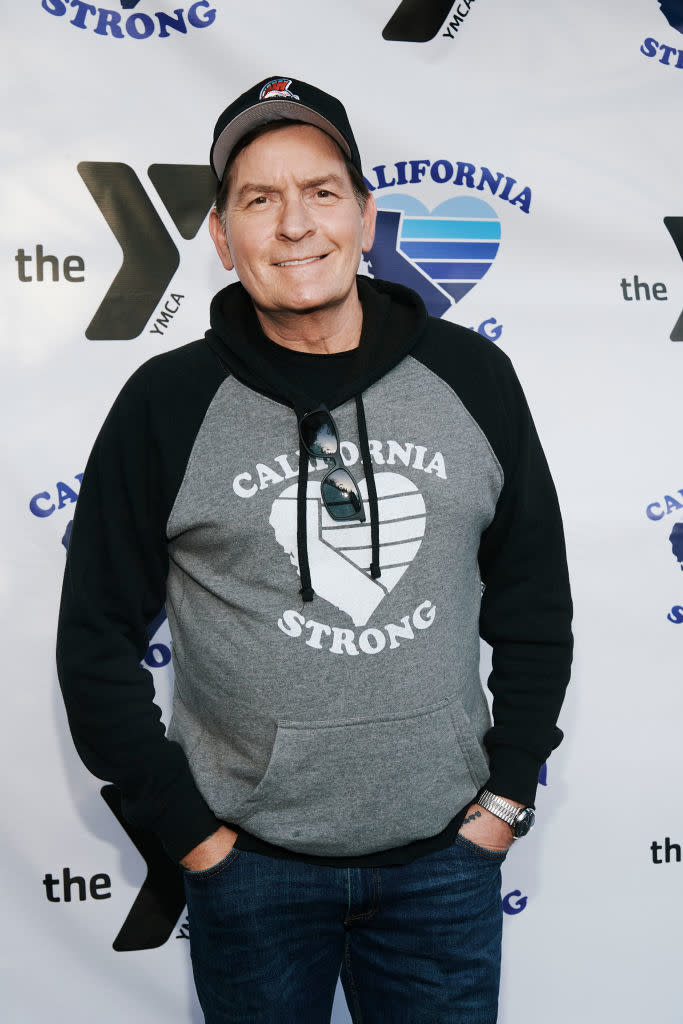 Charlie in a "California Strong" hoodie and cap posing at an event