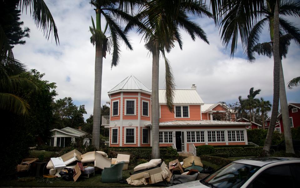 Waterlogged furniture sits on the curb in old Naples on Thursday, Sept. 29, 2022, after Hurricane Ian caused widespread flooding in the area. 