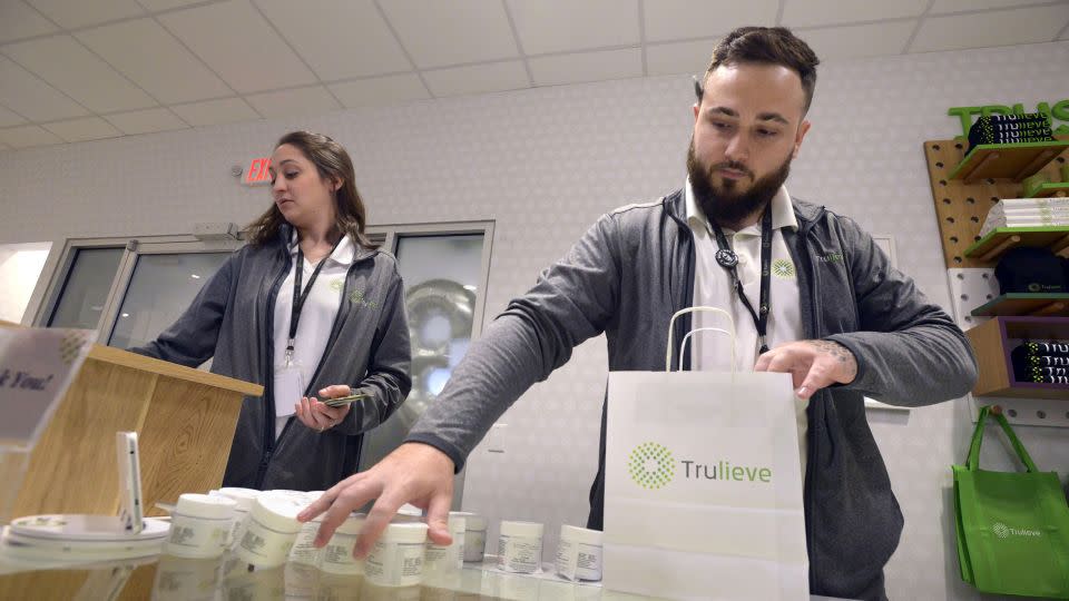 Leah Hartigan and Brandon Garcia ring up an order for a customer at the Trulieve Fort Walton Beach Dispensary in Florida in August 2020. - Devon Ravine/Northwest Florida Daily News/USA Today Network