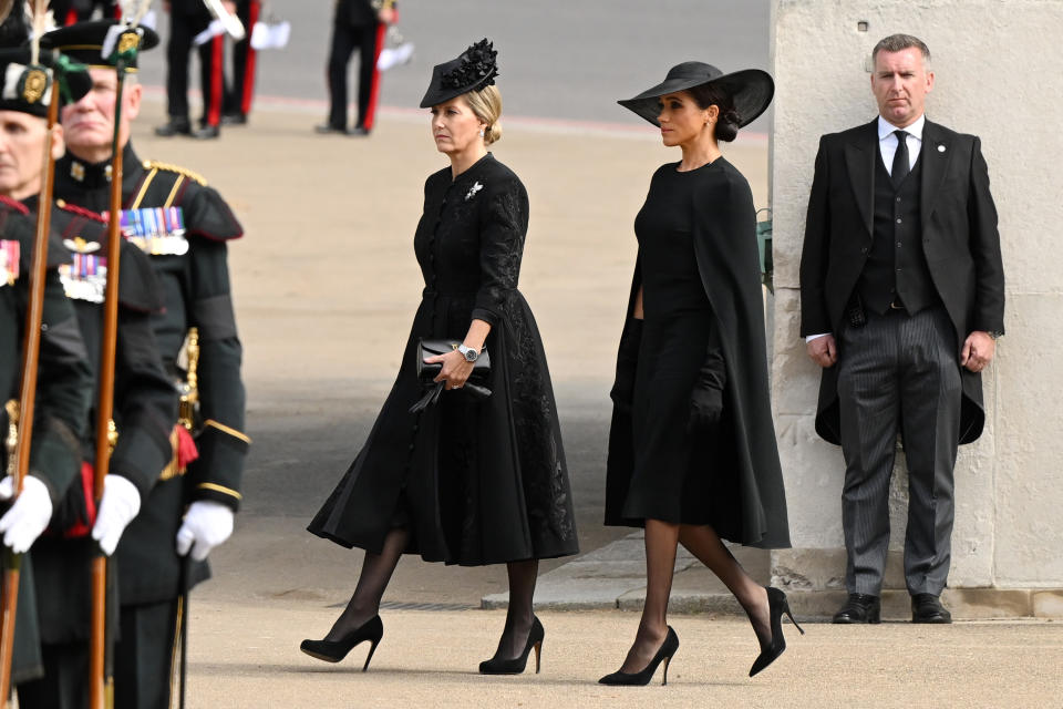 Meghan donned a caped black dress for the Queen's funeral. (Getty Images)