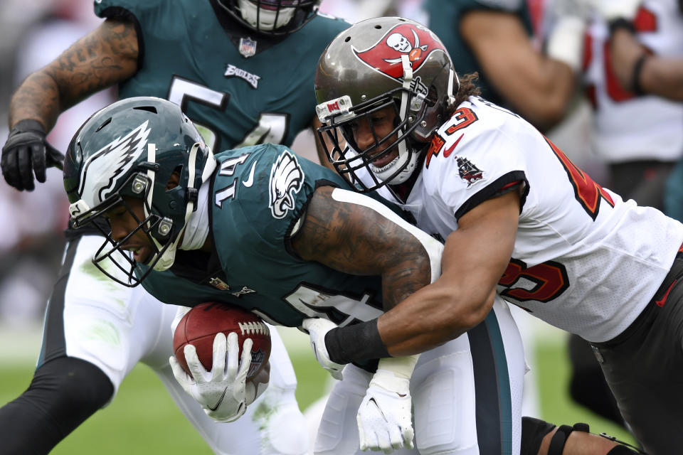 Philadelphia Eagles running back Kenneth Gainwell (14) is stopped by Tampa Bay Buccaneers cornerback Ross Cockrell (43) during the first half of an NFL wild-card football game Sunday, Jan. 16, 2022, in Tampa, Fla. (AP Photo/Jason Behnken)