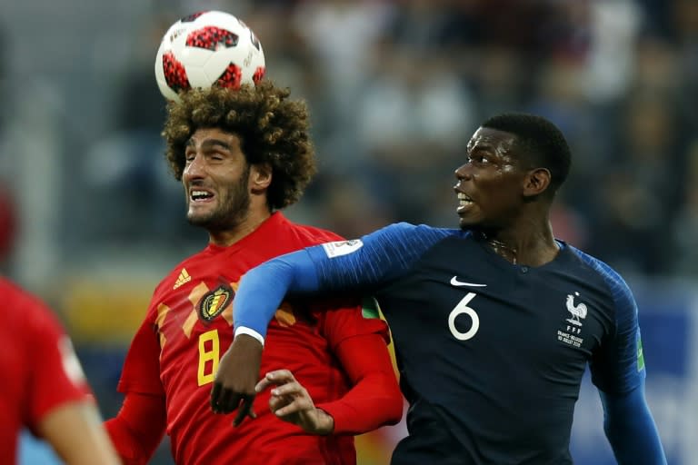 Physical battle: Paul Pogba (right) in action against Manchester United teammate Marouane Fellaini in the France v Belgium World Cup semi-final