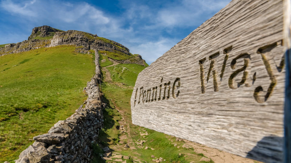 A wooden Pennine Way signpost