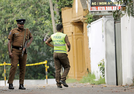 A Sri Lankan police officer walks into the motel where the Australian and British-educated suicide bomber had detonated his device inside, in Dehiwala on the outskirts of Colombo, Sri Lanka April 26, 2019. REUTERS/Dinuka Liyanawatte