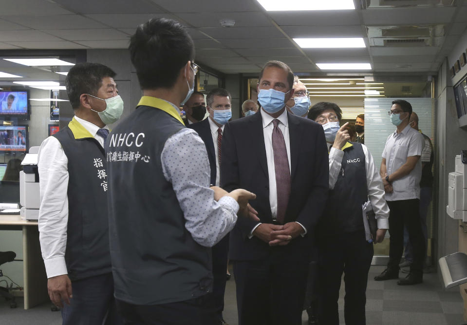 U.S. Health and Human Services Secretary Alex Azar, center, visits the National Health Command Center with Taiwanese Minister of Health and Welfare Chen Shih-chung, left, at the Central Epidemic Command Center in Taipei, Taiwan, Monday, Aug. 10, 2020. Azar arrived in Taiwan on Sunday in the highest-level visit by an American Cabinet official since the break in formal diplomatic relations between Washington and Taipei in 1979. (AP Photo/Chiang Ying-ying)