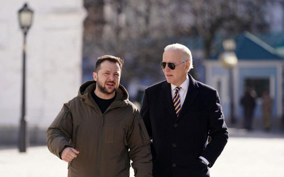 US President Joe Biden walks next to Ukrainian President Volodymyr Zelensky as he arrives for a visit in Kyiv - DIMITAR DILKOFF/AFP