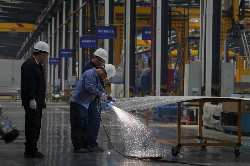 Worker weird a frame material for the Dongfeng truck at a manufacturing factory in Shiyan city in central China's Hubei Province on May 12, 2023. China's factory activity decelerated in May, a survey showed Wednesday, May 31 adding to signs its economic rebound after the end of anti-virus controls is slowing. (AP Photo/Andy Wong)