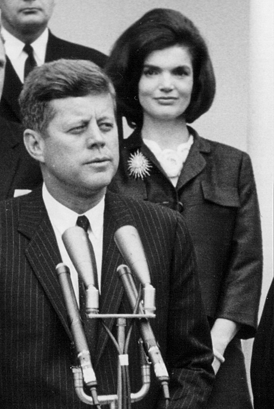 President John F. Kennedy speaks during a press conference as First Lady Jackie Kennedy looks on April 9, 1963 at the White House.  