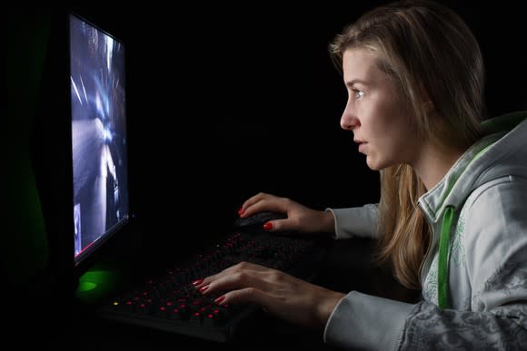 Woman playing video game stares intently at screen