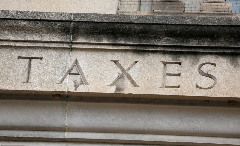 FILE PHOTO: The word "taxes" is seen engraved at the headquarters of the Internal Revenue Service (IRS) in Washington, D.C.