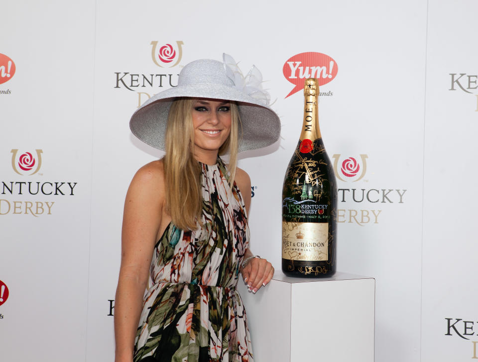 LOUISVILLE, KY - MAY 05: Red Carpet/Celebrity Signing Moment: Olympic Skier Lindsey Vonn signs a limited edition 6 Liter Moet & Chandon Imperial bottle for the brands philanthropic initiative "Sign for the Roses", on the red carpet at the 138th Kentucky Derby on May 5, 2012 in Louisville, Kentucky. (Photo by Joey Foley/Getty Images for Moet)