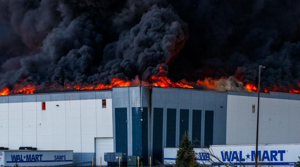 A massive fire burns inside a Walmart fulfillment center in Plainfield, Ind., near the Indianapolis International Airport.