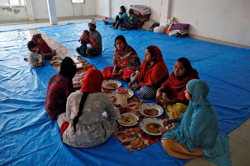 Muslims have their meals as they take shelter at Al Hind hospital after they fled their homes following clashes between people demonstrating for and against a new citizenship law in a riot affected area in New Delhi