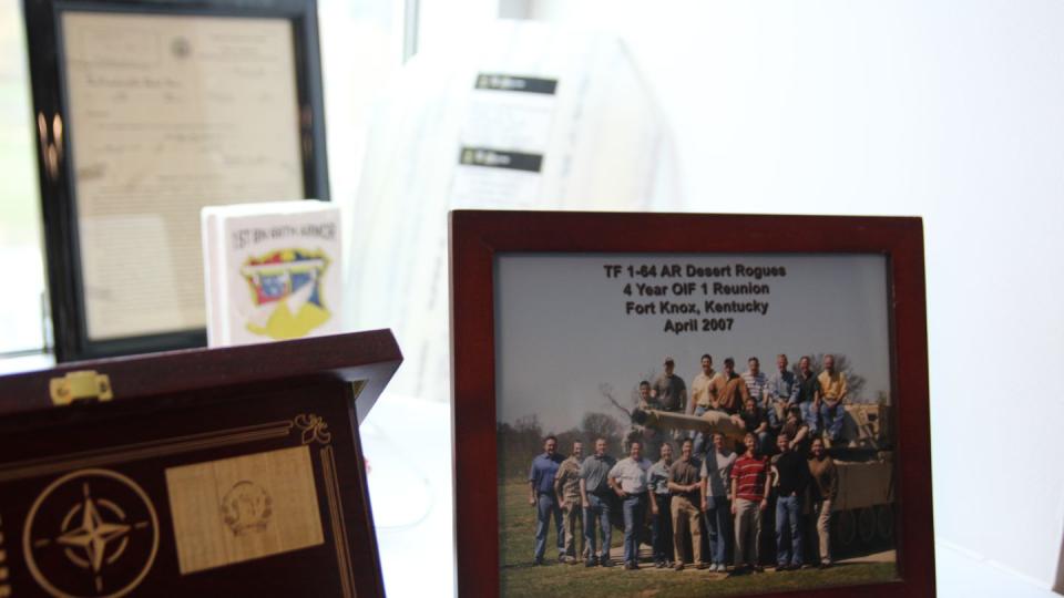 In his Fort Benning, Georgia office, Brig. Gen. Larry Burris, today the Infantry School commandant, displays a Task Force 1-64 reunion photo. The unit led the Army’s drive into Baghdad in April 2003, including the famous Thunder Runs. (Staff/Davis Winkie)