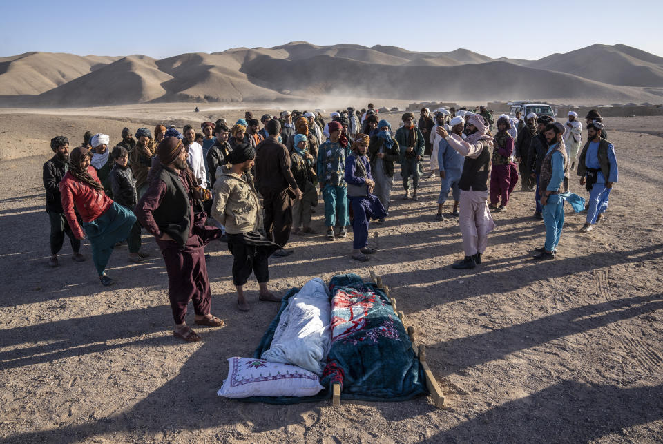 Afghans prepare for a pray for relatives killed in an earthquake to a burial site after an earthquake in Zenda Jan district in Herat province, western of Afghanistan, Sunday, Oct. 8, 2023. Powerful earthquakes killed at least 2,000 people in western Afghanistan, a Taliban government spokesman said Sunday. It's one of the deadliest earthquakes to strike the country in two decades. (AP Photo/Ebrahim Noroozi)