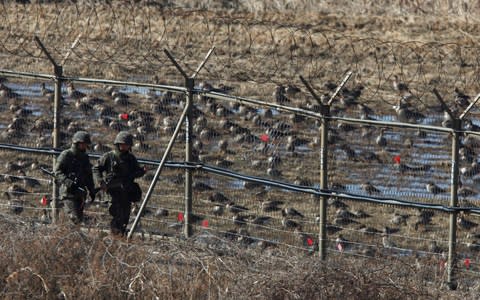 South Korean soldiers patrol along a barbed-wire fence near the demilitarized zone (DMZ) - Credit:  Kim Hong-Ji/ REUTERS