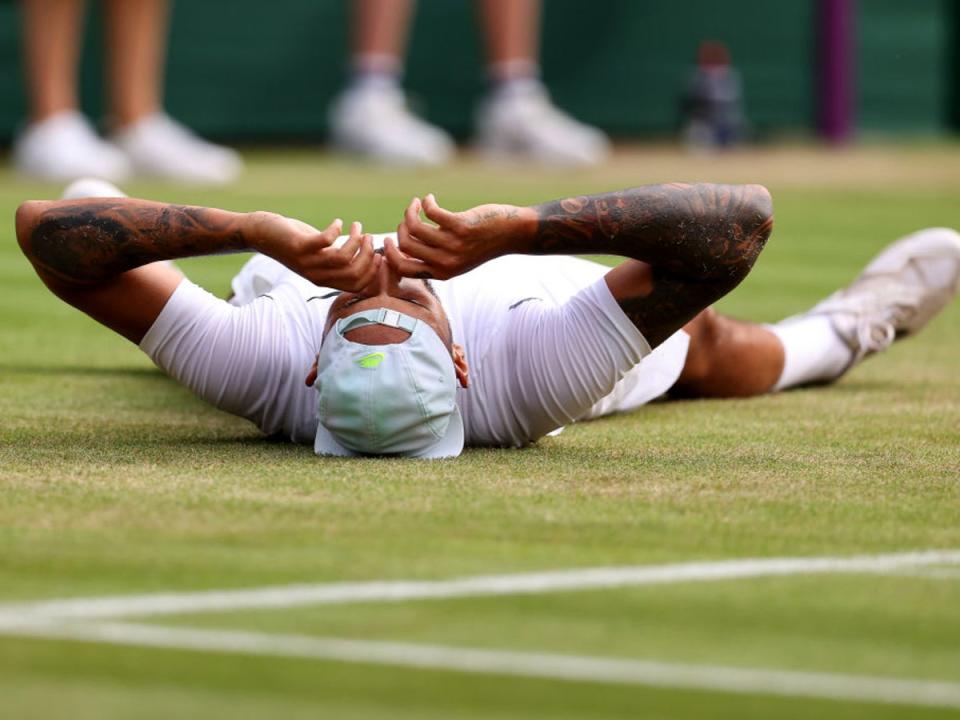 Nick Kyrgios collapses on the court after sealing victory (Getty Images)