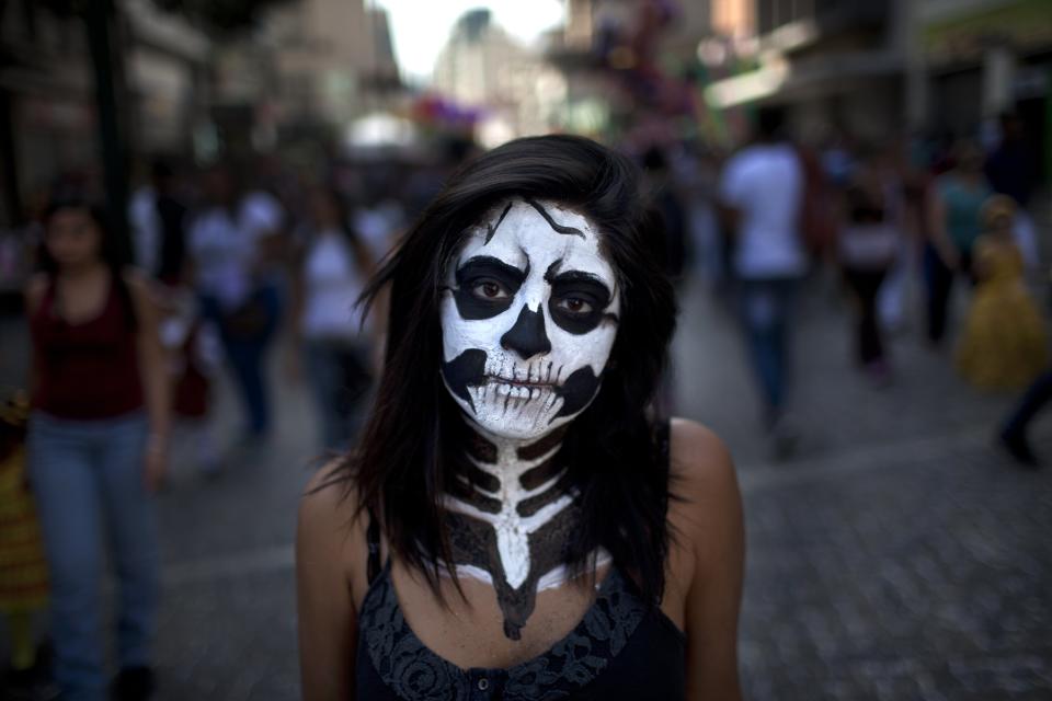 Diana Bochaga, 18, poses for a picture during Carnival celebrations in Caracas, Venezuela, Tuesday, March 4, 2014. Some Venezuelans are taking time off for carnival despite two weeks of nation-wide opposition protests. A year after the death of Hugo Chavez, Venezuela has been rocked by weeks of violent protests that the government says have left several dead. President Maduro appears ready to use Chavez's almost mythical status to steady his rule as protesters refuse to leave the streets. (AP Photo/Rodrigo Abd)