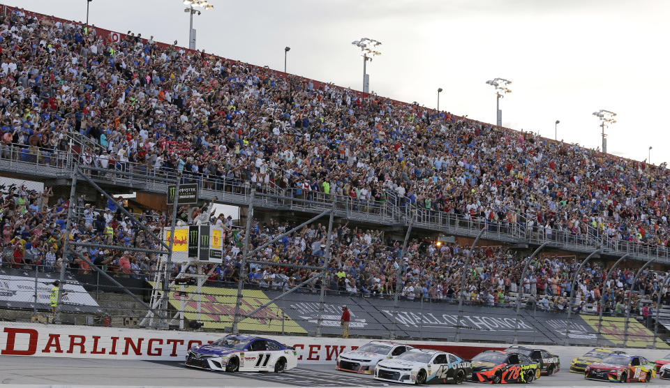 Denny Hamlin (11) leads the pack to start the NASCAR Cup Series auto race at Darlington Raceway, Sunday, Sept. 2, 2018, in Darlington, S.C. (AP Photo/Terry Renna)