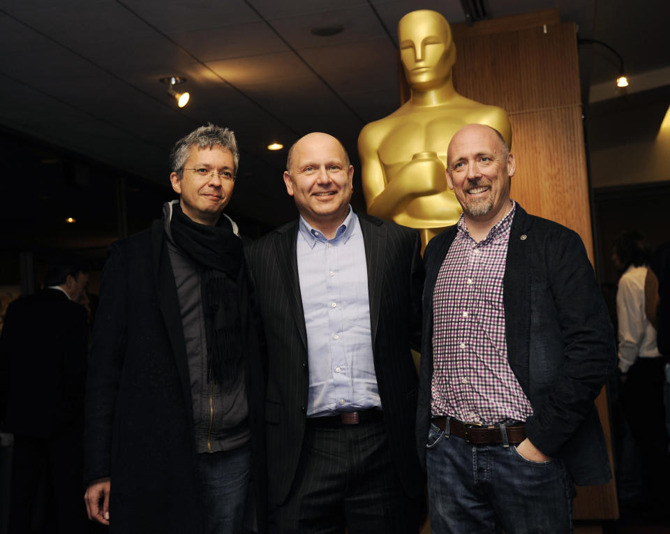 Pierre Coffin, left, and Chris Renaud, right, co-directors of the Oscar-nominated feature film "Despicable Me 2," pose with producer Chris Meledandri at a reception featuring the Oscar nominees in the Animated Feature Film category on Friday, Feb. 28, 2014, in Beverly Hills, Calif. The 86th Oscars ceremony will be held on Sunday at the Dolby Theatre in Los Angeles. (Photo by Chris Pizzello/Invision/AP)