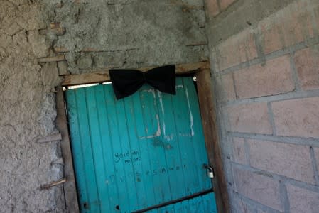 A black ribbon is seen at the door frame of the house of late Honduran migrant Herrera in El Limon