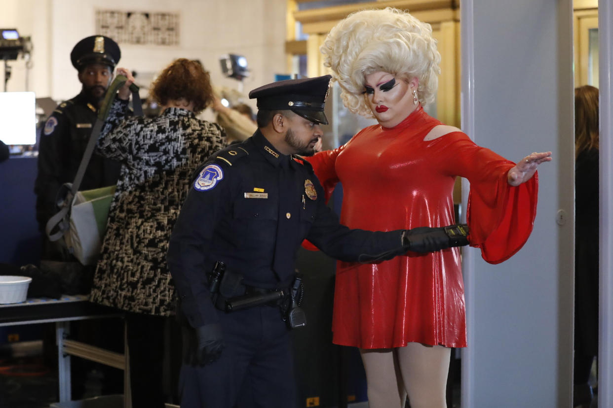 Pissi Myles, right, a special contributor with Happs News, a live news source that streams through Twitter, goes through security, Wednesday, Nov. 13, 2019, on Capitol Hill in Washington, as she arrives for the first public impeachment hearings of President Donald Trump's efforts to tie U.S. aid for Ukraine to investigations of his political opponents. (AP Photo/Jacquelyn Martin)