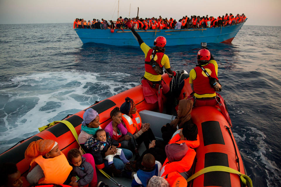 <p>Migrants from Eritrea hold their children after been rescued from a crowded wooden boat as they were fleeing Libya, during a rescue operation in the Mediterranean sea, about 13 miles north of Sabratha, Libya, Monday, Aug. 29, 2016. (AP Photo/Emilio Morenatti) </p>