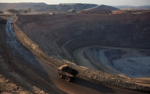 KOLWEZI, DRC- JULY 7: The sun sets on one of the open pit copper mines at Mutanda Mining Sarl on July 6, 2016 in Kolwezi, DRC. The mine is owned (69%) by Glencore, an Anglo-Swiss multinational commodity trading and mining company. The mine is mainly producing copper but also some cobalt. The mine employs about 3,500 people and its located in Luabala Province in Southern DRC. A truck carries a load of ore to the processing plant. (Photo by Per-Anders Pettersson/Getty Images) - Credit: Per-Anders Pettersson