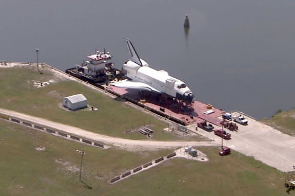 A high-fidelity mockup of a NASA space shuttle sits atop the barge taking it Houston, Texas, as seen on May 23, 2012, the day before it departed from the Kennedy Space Center, Fla.