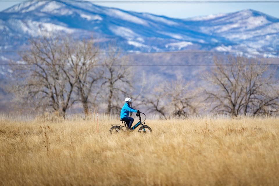 A biker rides along the Boyd Lake State Park bike trail in March 2022.