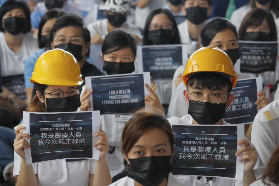 Medical staff take part in a protest against police brutality on the protesters, at a hospital in Hong Kong, Tuesday, Aug. 13, 2019. (Photo: Kin Cheung/AP)