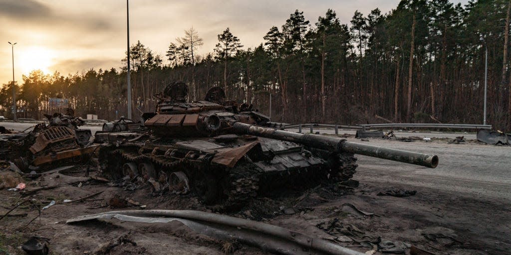 A destroyed Russian tank along the side of the road in Ukraine.