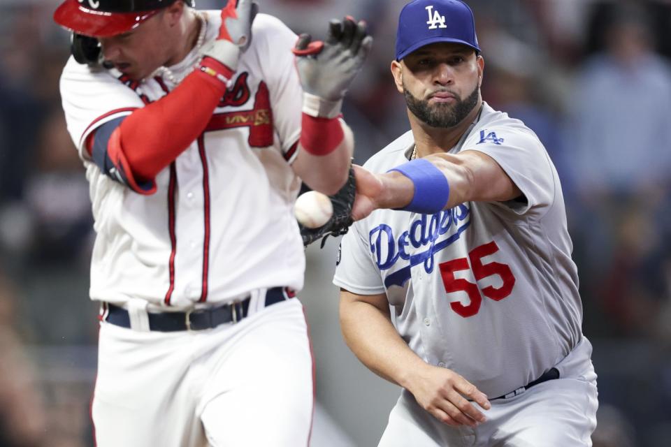 Braves' Joc Pederson reaches first before the catch by Dodgers first baseman Albert Pujols