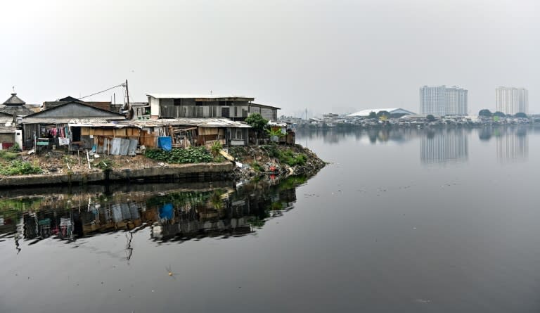 Public houses reach the edge of a reservoir in northern Jakarta