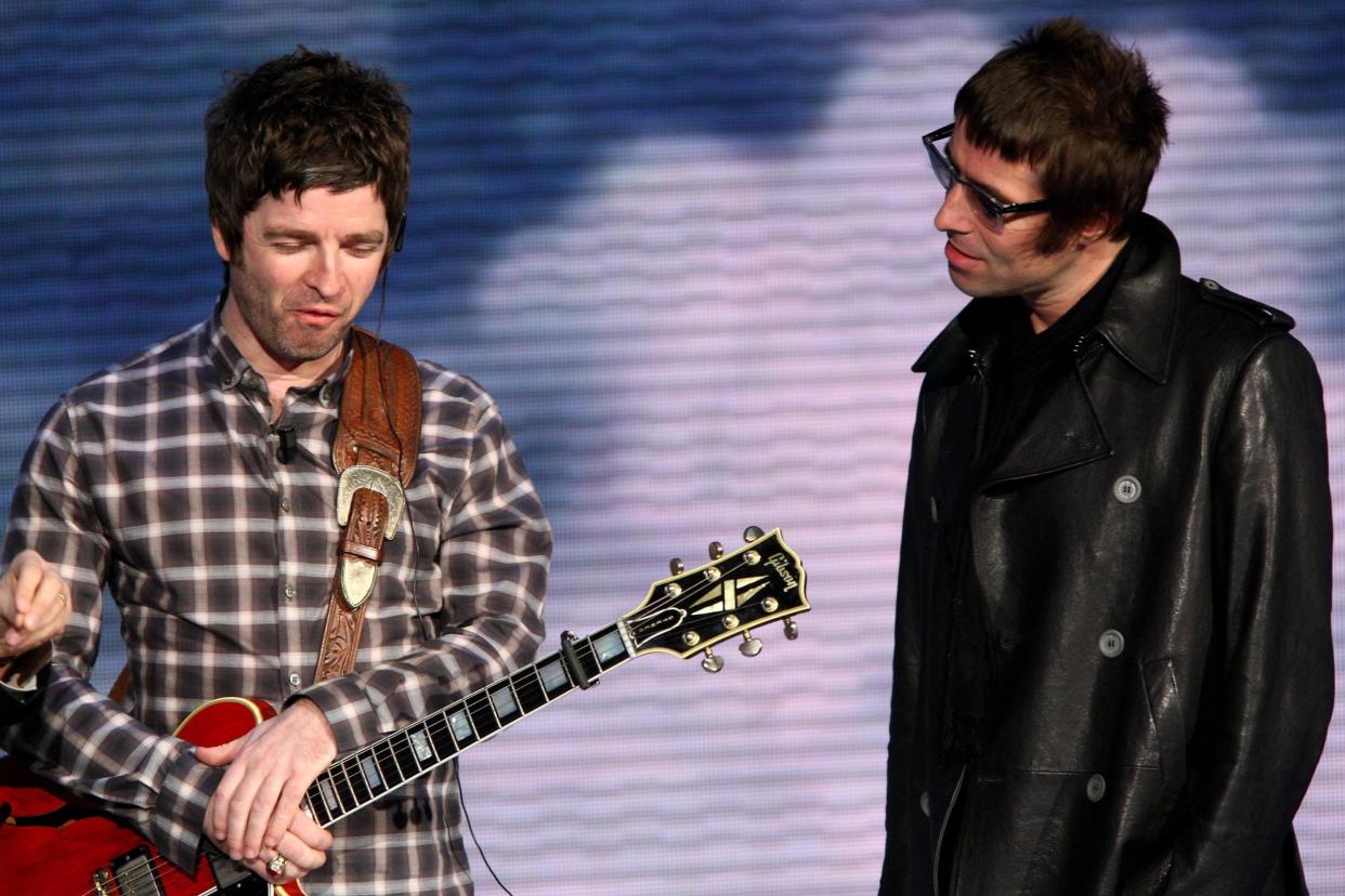 Liam Gallagher, right, has asked his brother Noel, left, to join him in getting Oasis back together: Getty Images