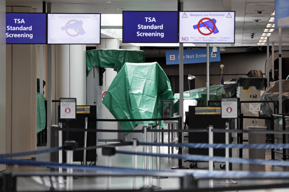 TSA equipment is covered with plastic at Orlando International Airport that was closed Tuesday, Sept. 3, 2019 due to the anticipated arrival of Hurricane Dorian on the East Coast, in Orlando, Fla. (AP Photo/John Raoux)