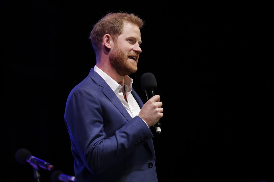 Britain's Prince Harry speaks on stage during a concert hosted by his charity Sentebale at Hampton Court Palace, in London, Tuesday June 11, 2019. The concert will raise funds and awareness for Sentebale, the charity founded by Prince Harry and Lesotho's Prince Seeiso in 2006, to support children and young people affected by HIV and AIDS in Lesotho, Botswana and Malawi. (AP Photo/Matt Dunham, Pool)