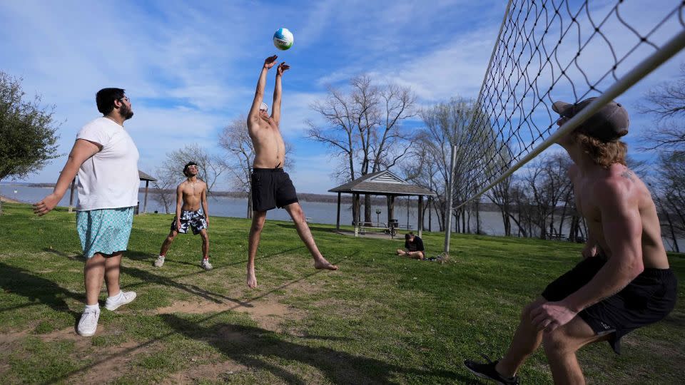 Friends play volleyball during a day that felt more like June than February in Grand Prairie, Texas, on Monday, February 26. - Julio Cortez/AP