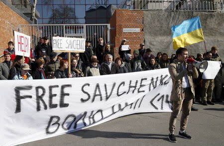 People take part in a rally demanding the liberation of Ukrainian army pilot Nadezhda Savchenko by Russia, near the European Union mission to Ukraine in Kiev, Ukraine, March 8, 2016. REUTERS/Valentyn Ogirenko