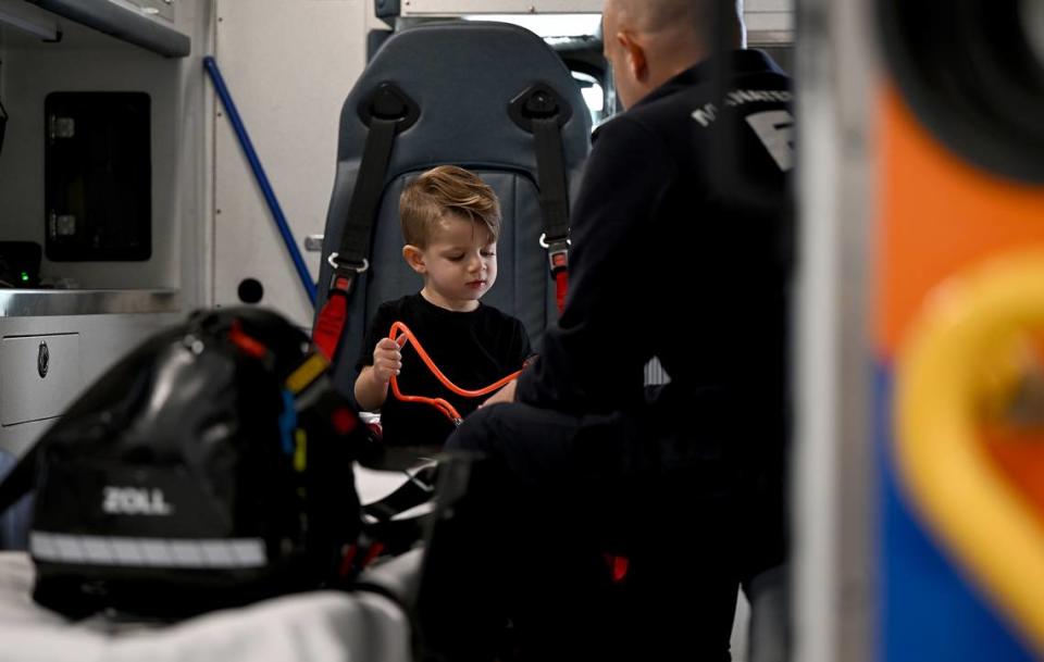 Nolan Backus, 2 1/2, uses a stethoscope in the back of an ambulance at EMS Station 10. Backus got to meet the Manatee County charge paramedic Kevin Guido, 36, who treated him in an ambulance after he suffered a seizure at his daycare in March.